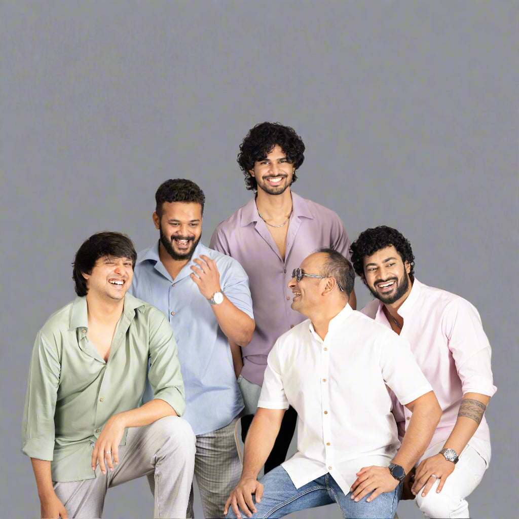 Five men sitting together on a plain background