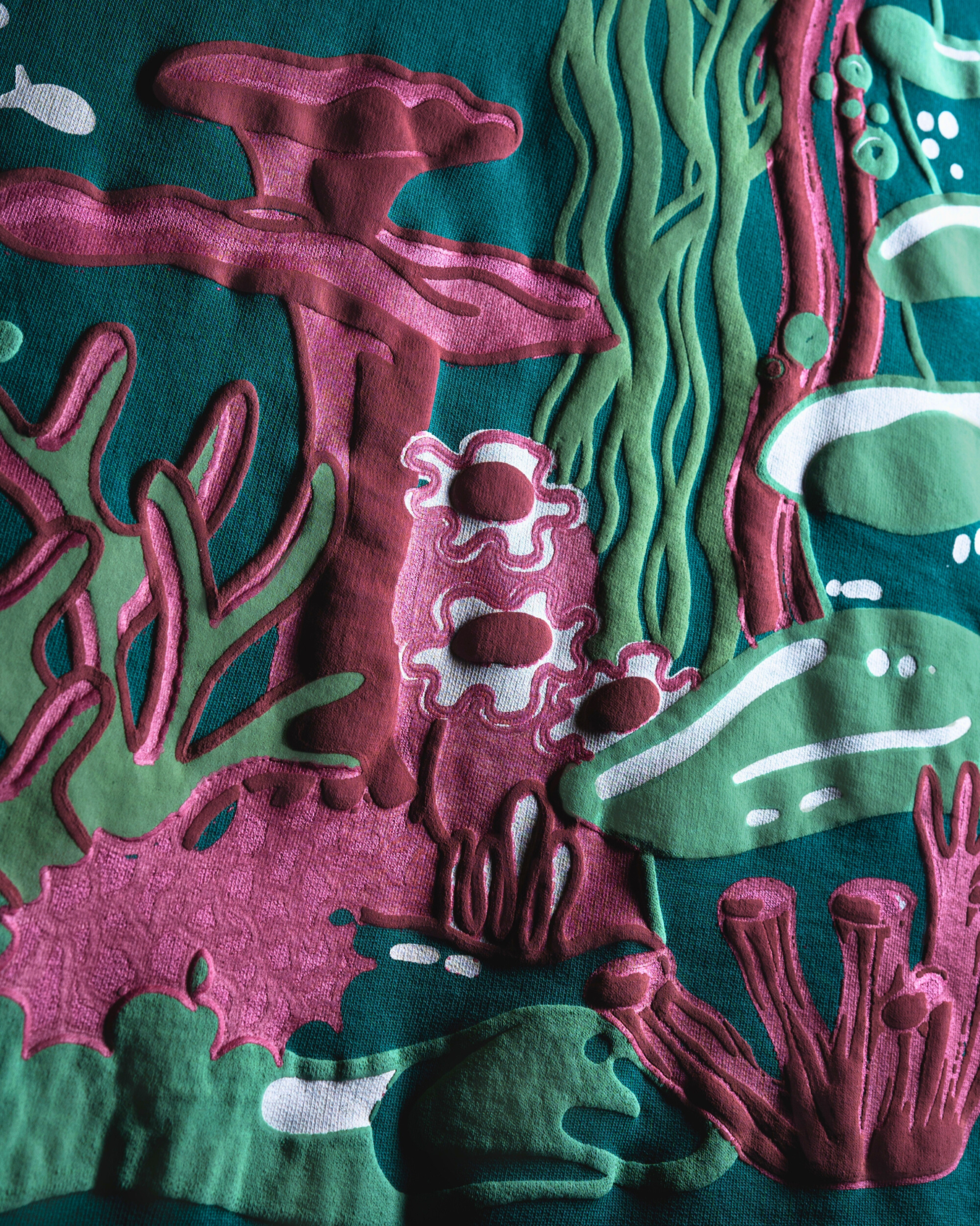 Colorful underwater scene with fishes and coral on a textured surface