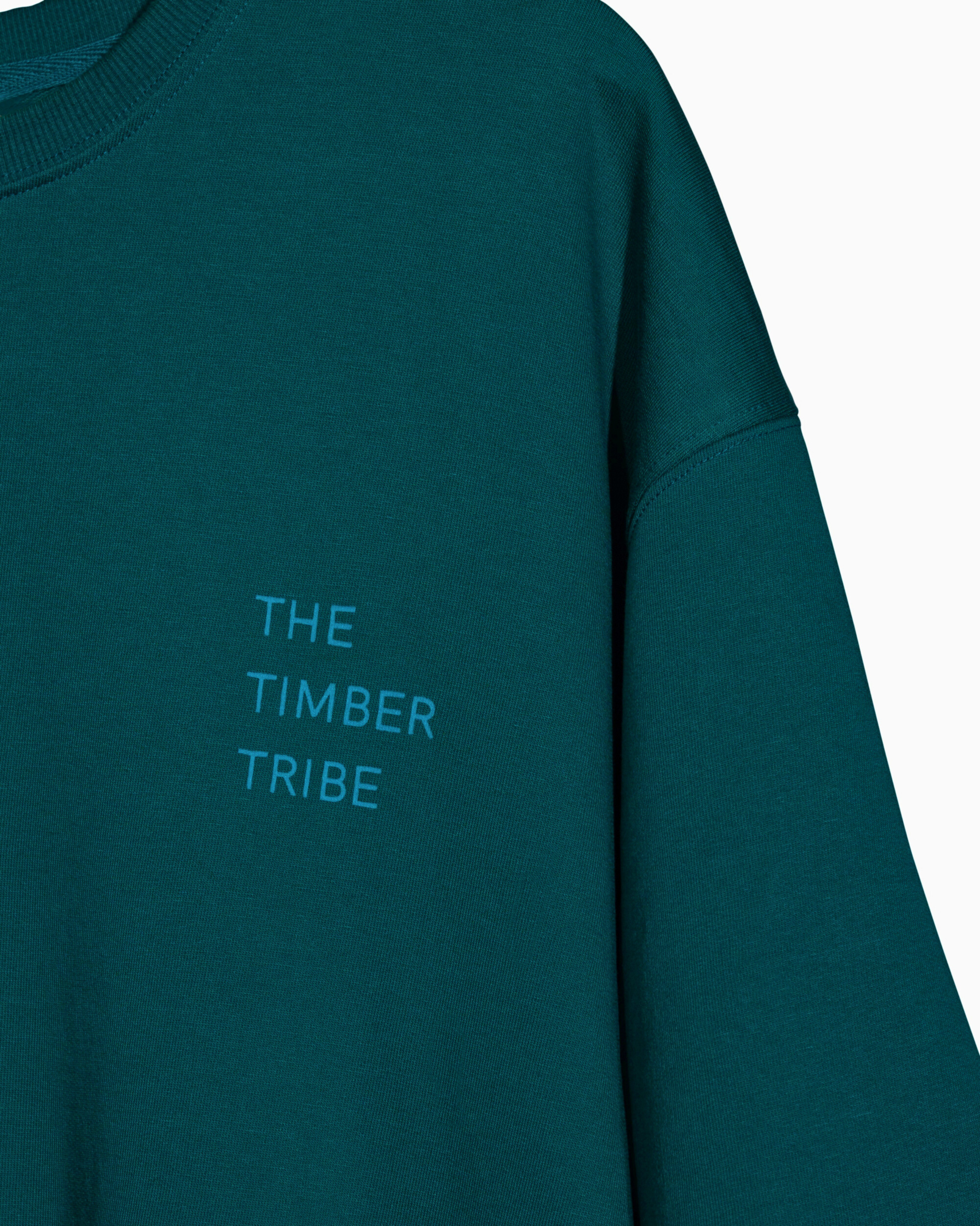 Teal t shirt with 'The Timber Tribe' text on a white background