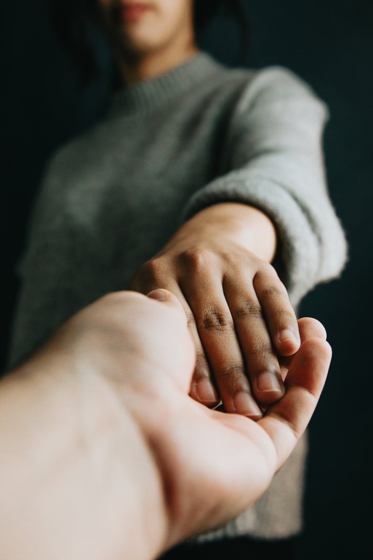 Empowering gesture of hands connecting, representing ethical partnerships